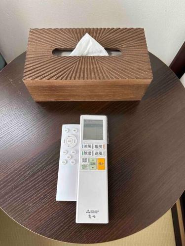a remote control and a box on a table at Yoshimura igariya in Azagawa