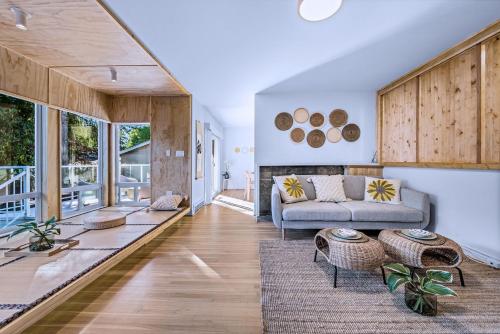 a living room with a couch and a table at Three-Tree Villa-Central Location in Vancouver