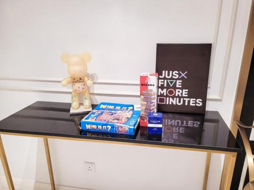 a table with books and a stuffed animal on it at The Ress - The Axon Bukit Bintang Residence in Kuala Lumpur