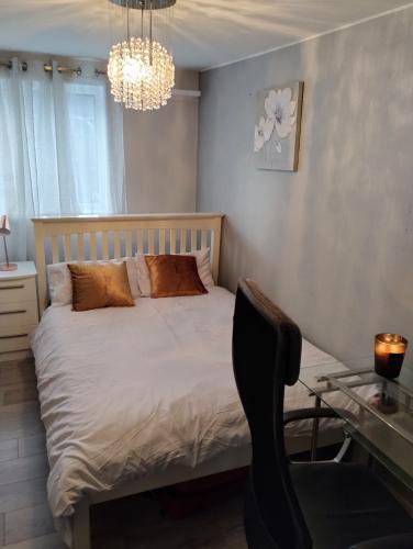 a bedroom with a bed and a desk with a chair at Double room In Corby in Rockingham