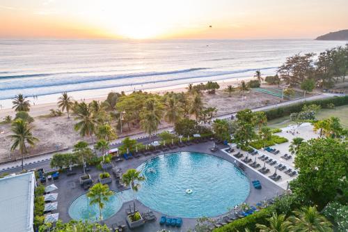 an overhead view of the pool and beach at the resort at Pullman Phuket Karon Beach Resort in Karon Beach