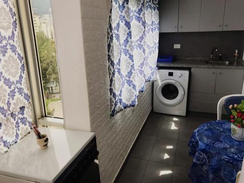 a kitchen with a washing machine and a window at Chalet in Jounieh, pool, amazing sea view, wifi Maameltein 