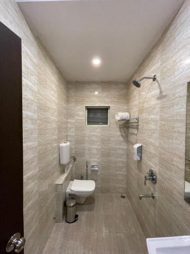 a bathroom with a toilet and a sink and a shower at Zip By Spree Hotels Bhopal in Bhopal
