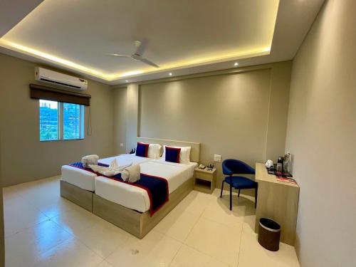 a bedroom with a bed and a desk and a chair at Zip By Spree Hotels Bhopal in Bhopal