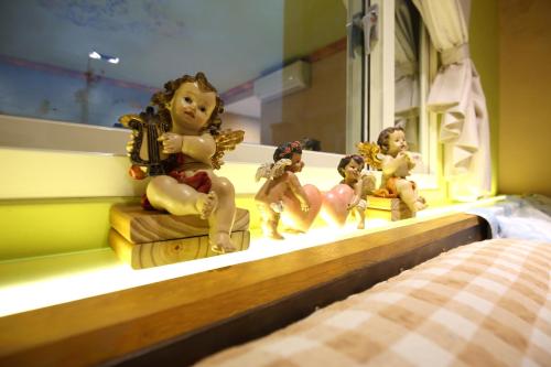 a group of little figurines sitting on a shelf at Sweet Heart B&B in Jian