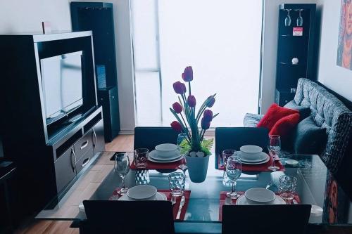 a living room with a table and a tv at Secure, central and quiet apartment work or travel in Mexico City
