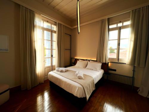 a bedroom with a bed with two towels on it at Heart Hotel in Limassol