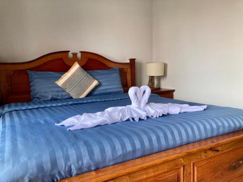 a bed with a towel on top of it at Lotus Haven Villa in Siem Reap