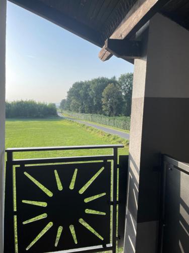 a black gate with a view of a field at IL Sole in Caselle Torinese