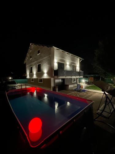 a swimming pool in front of a house at night at IL Sole in Caselle Torinese