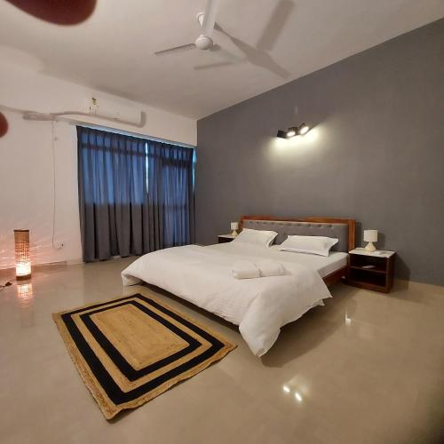 a bedroom with a large white bed and a window at The skyline suite. in Lucknow