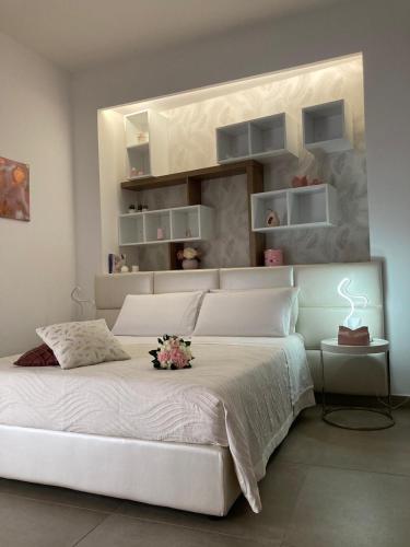 a bedroom with a large white bed with flowers on it at Love inn in Pompei