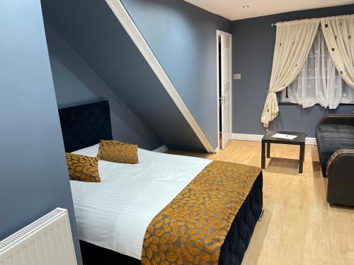 1 dormitorio con 1 cama y 1 sofá en una habitación en Apartment & Rooms in London, en Croydon