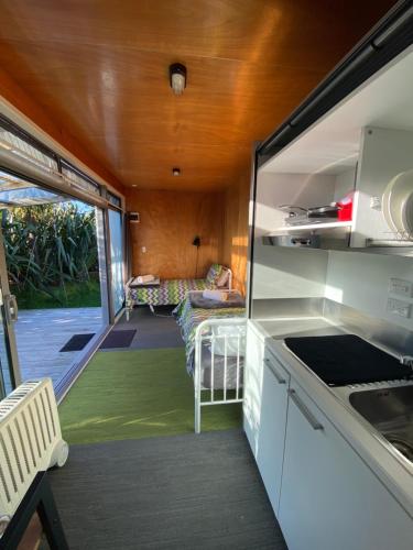 a kitchen and living room in a tiny house at Ross Beach TOP10 Holiday Park in Ross