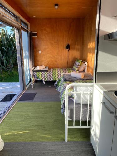 a room with a bed and a couch in a house at Ross Beach TOP10 Holiday Park in Ross