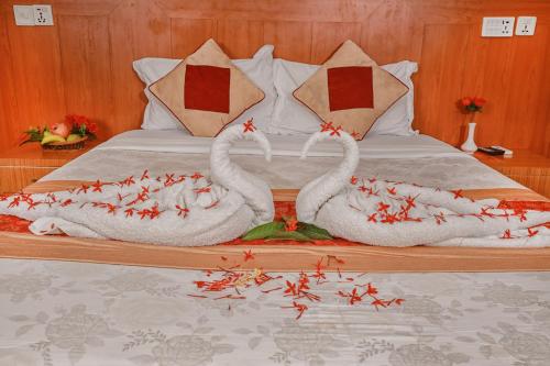 a bed with two swans made out of towels at Hotel Wildlife Camp in Sauraha