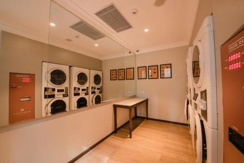 a laundry room with washing machines and a counter at Ramayana Suites and Resort in Kuta