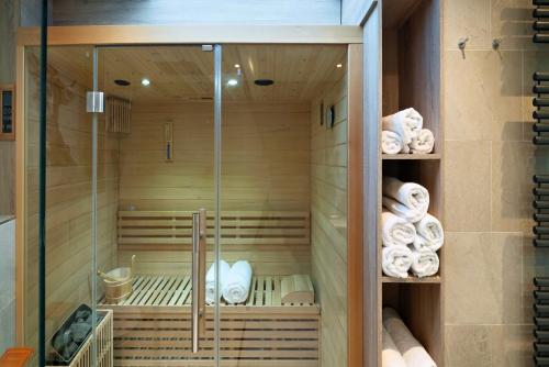 a walk in shower with towels in it at Alpin Kanker Suites 1 in Garmisch-Partenkirchen