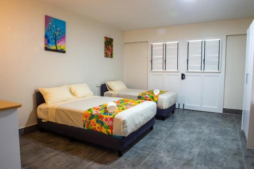 a bedroom with two beds and a window at Yatulau Hotel and Conference in Suva