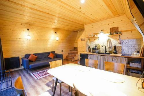 a living room with a couch and a table at Kazbegi Spa Resort Cottages in Stepantsminda