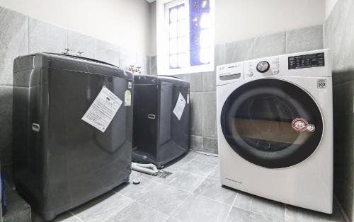 a washing machine and a dryer in a bathroom at STAY201 in Jecheon