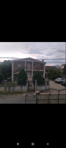 a large building with a fence in front of it at VILA LUKA in Podgorica