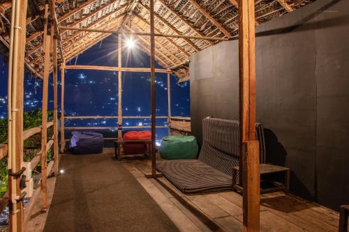 a gazebo with a chair and a window at Deck on the hills Bunks in Kandy