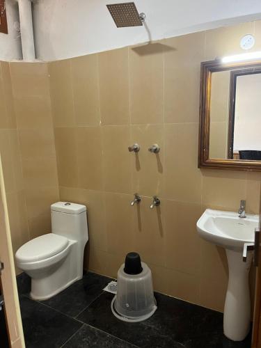a bathroom with a toilet and a sink at ANAND Beach Guesthouse by Moonrocks in Mahabalipuram