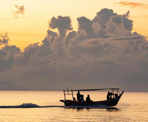 a group of people on a boat in the water at PULANG RESORT in Setiu