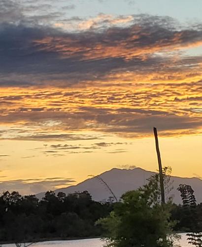 a sunset with a mountain in the background at PULANG RESORT in Setiu