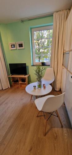 a living room with two tables and a window at Bulle D'eau in Spa