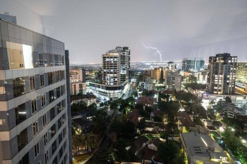 a view of a city at night with lightning at Spacious 2BR APT Near Sandton City -No Loadshedding in Johannesburg