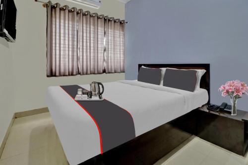 a bedroom with a large white bed in a room at Flagship Hotel Sai Orchid in Bangalore