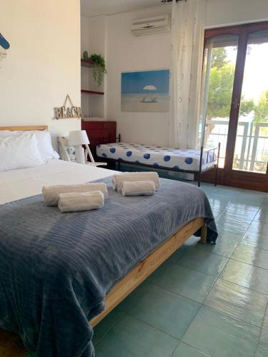 a bedroom with a bed with two towels on it at Rocca Mondello Rooms, Beach and Sea in Palermo
