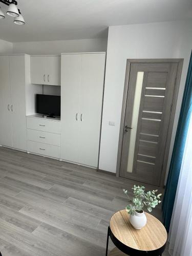 a living room with a table with a vase on it at Luxury Apartments and Studios Boulevard G Enescu Suceava in Suceava