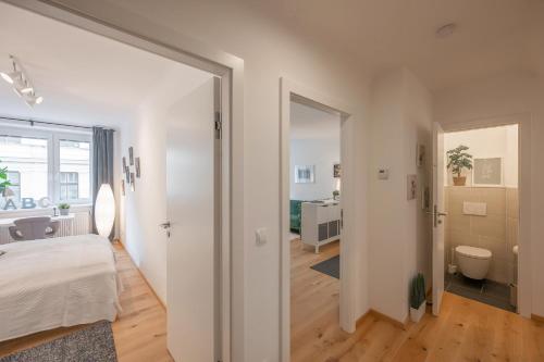 a bedroom with a large door leading to a bathroom at Modern City Center Apartment in Vienna