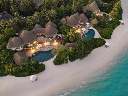 an aerial view of a resort on a beach at The Nautilus Maldives in Baa Atoll