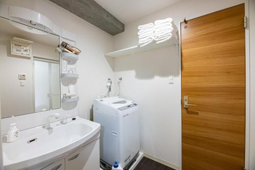 een badkamer met een wastafel en een wasmachine bij STAYTUS - Vacation STAY 62201v in Kagoshima