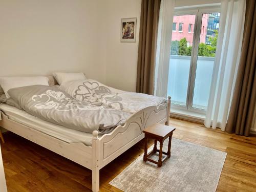 a white bed in a room with a window at Wien an Donau in Vienna