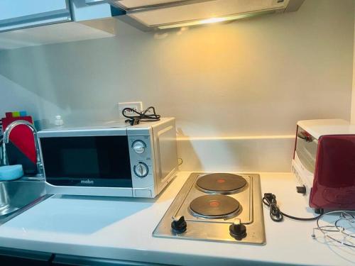 a microwave sitting on a counter next to a stove at UNIT 4765 AIR in Manila