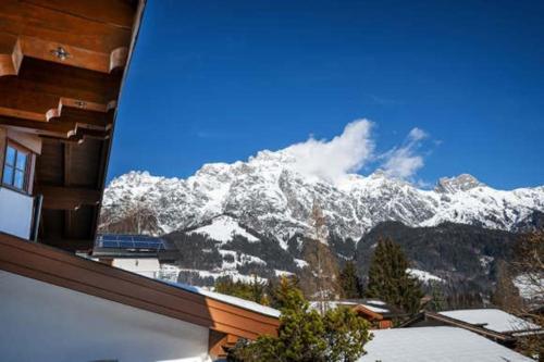 a view of a snow covered mountain from a house at Chalet Steinberg in Leogang
