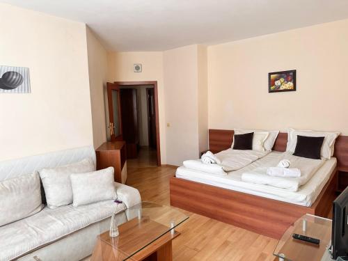 a living room with two white couches and a couch at Spacious studio sleeps 4 in Flora main building 706A in Borovets