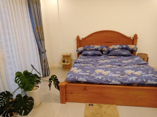 a bedroom with a bed and a potted plant at C113 Home-1bedroom in Phnom Penh
