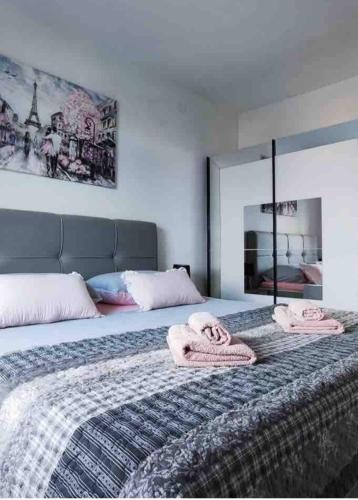a bedroom with a bed with two towels on it at Apartments Ita - Postira in Postira