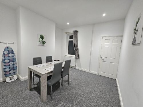 a dining room with a table and chairs at 52 Wordsworth Street by Prestige Properties SA in Barrow in Furness