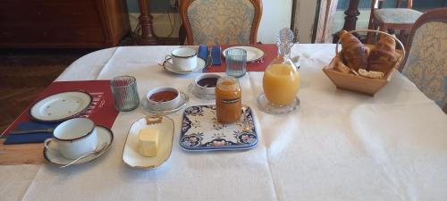 L'HERMITAGE D'ALIENOR في Lugon et l’Ile du Carney: طاولة مع طبق من الطعام وعصير البرتقال