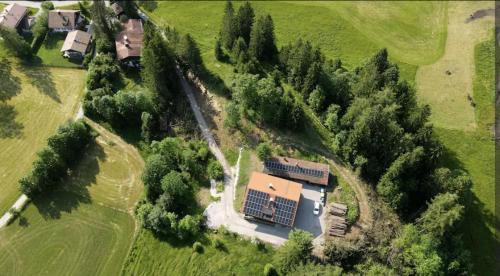 an aerial view of a house in the middle of a field at Gemütliches Berg-Chalet mit Panoramablick in Bayrischzell