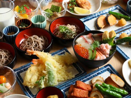 a table with plates of food and bowls of food at Onyado Nono Matsue Natural Hot Spring in Matsue