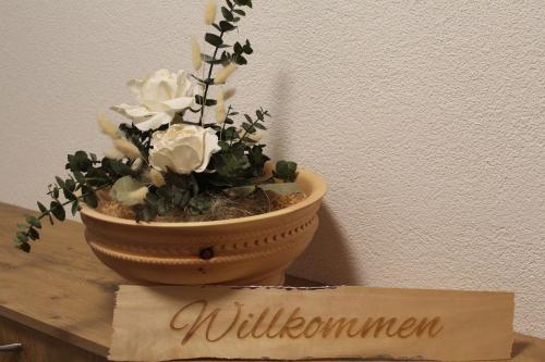 a vase with flowers in it sitting on a table at Landhaus Eiter in Arzl im Pitztal