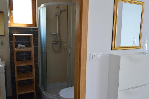 a bathroom with a shower with a toilet and a sink at Villa Gloria in Mimice